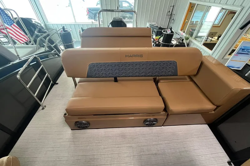 Slide: The Image of 2025 Harris Solstice 230 boat interior with tan seating and modern design. - 11