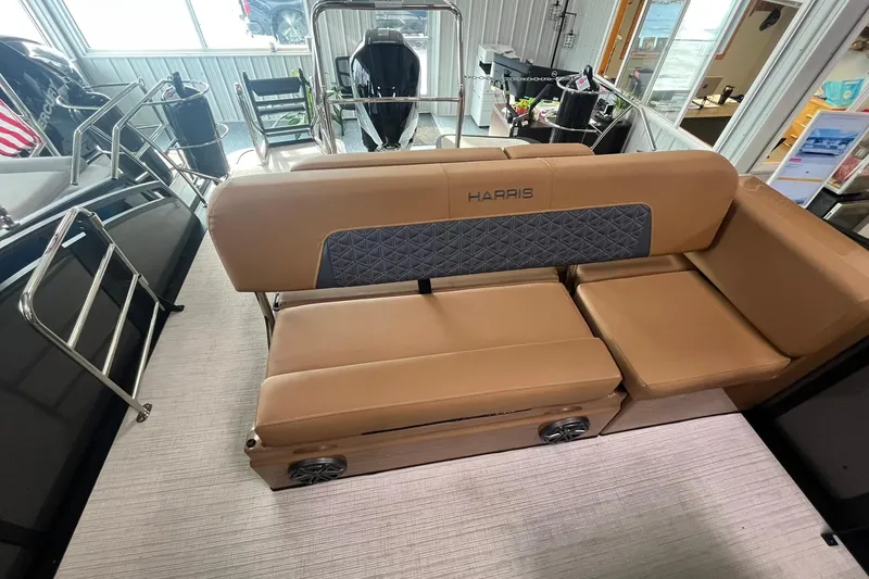 Slide: The Image of 2025 Harris Solstice 230 boat interior with tan seating and modern design. - 12