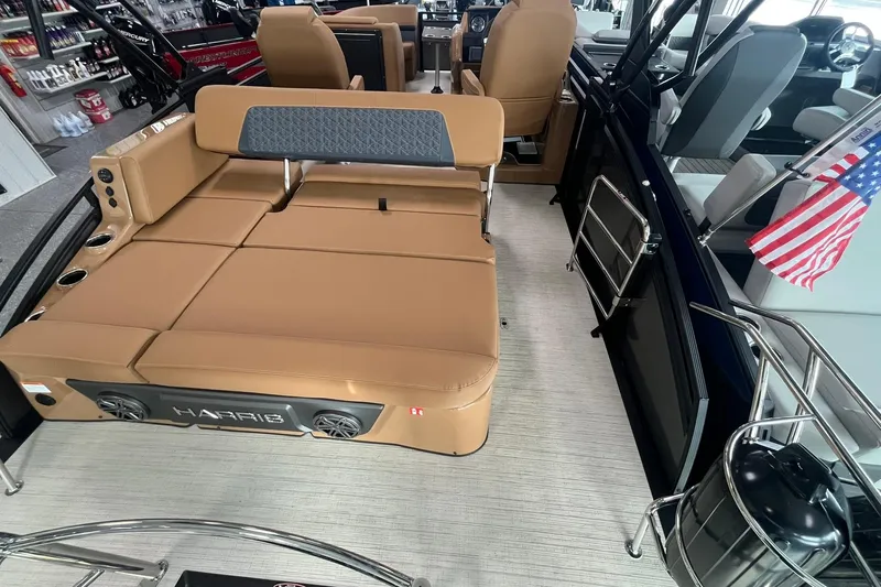 Slide: The Image of 2025 Harris Solstice 230 boat interior with tan seating and American flag. - 15