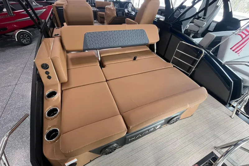 Slide: The Image of 2025 Harris Solstice 230 boat interior with tan seating and cup holders. - 16