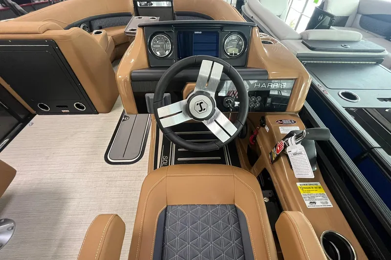 Slide: The Image of 2025 Harris Solstice 230 boat interior with modern steering wheel and dashboard controls. - 19