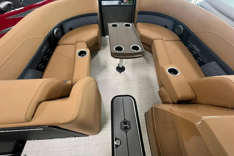 Slide: The Image of Luxurious interior of 2025 Harris Solstice 230 pontoon boat with tan seating and table. - 21