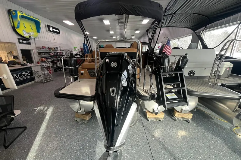 Slide: The Image of 2025 Harris Solstice 230 pontoon boat displayed in a showroom with accessories. - 3
