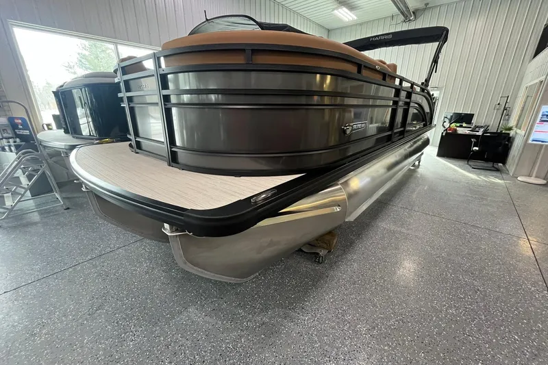 Slide: The Image of 2025 Harris Solstice 230 pontoon boat in showroom, sleek design, modern features. - 4