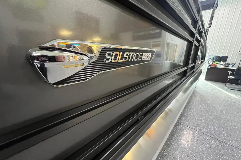 Slide: The Image of 2025 Harris Solstice 230 boat emblem in showroom, showcasing sleek design and modern features. - 5