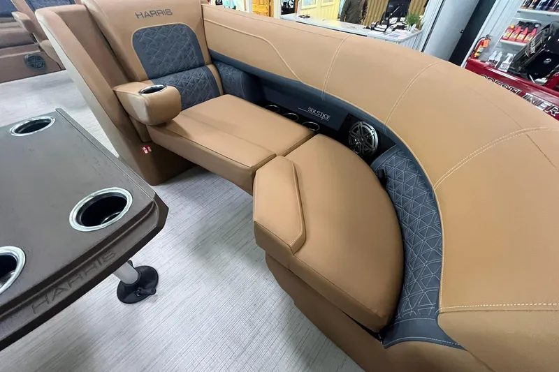 Slide: The Image of Luxurious interior of 2025 Harris Solstice 230 boat with tan seating and cup holders. - 8