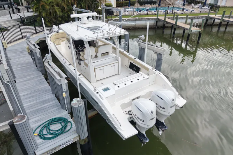 Slide: The Image of 2020 Pursuit S 328 Sport boat docked with dual Yamaha engines. - 11