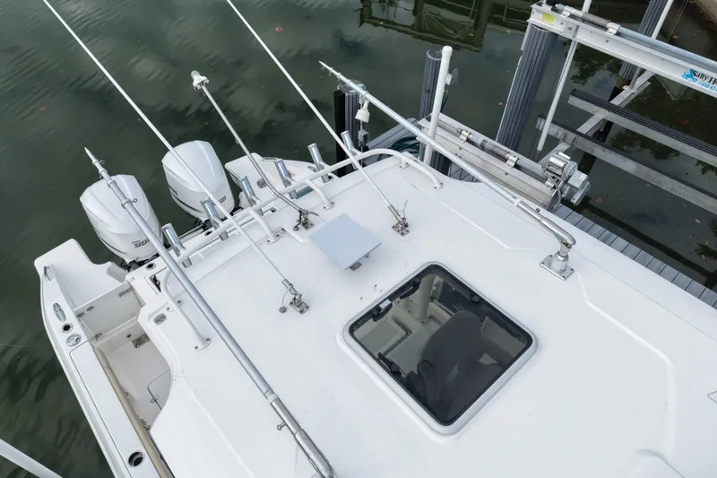 Slide: The Image of 2020 Pursuit S 328 Sport boat with dual engines and fishing rod holders. - 12