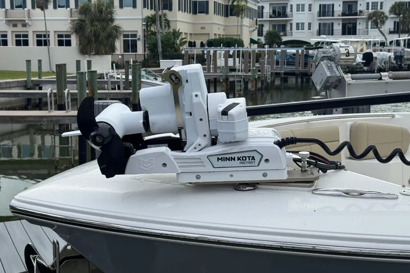Slide: The Image of Minn Kota Instinct motor on 2020 Pursuit S 328 Sport boat docked at marina. - 13
