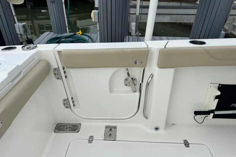 Slide: The Image of 2020 Pursuit S 328 Sport boat interior with beige accents and stainless steel fixtures. - 19