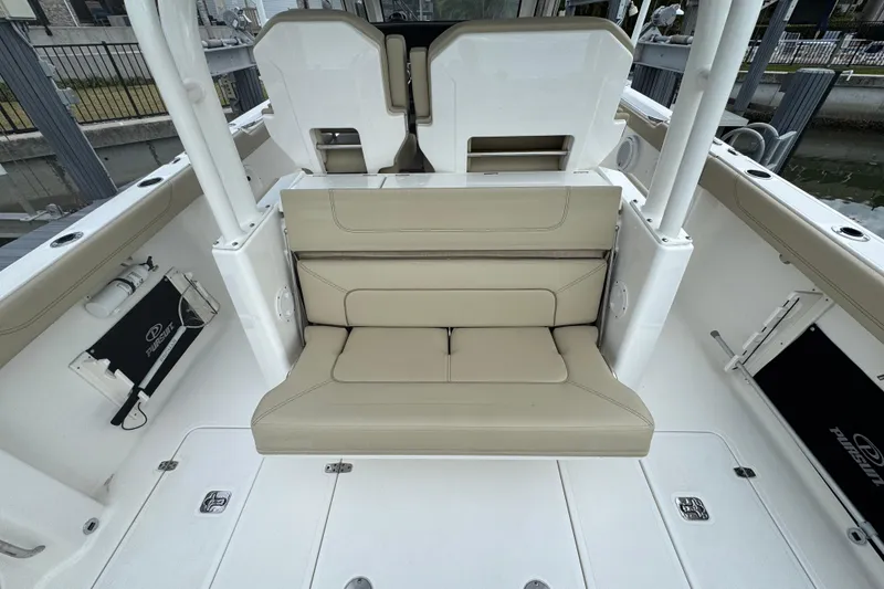 Slide: The Image of 2020 Pursuit S 328 Sport boat interior with beige seating and white deck. - 20