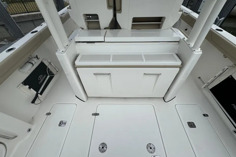 Slide: The Image of 2020 Pursuit S 328 Sport boat interior with storage compartments and seating area. - 21
