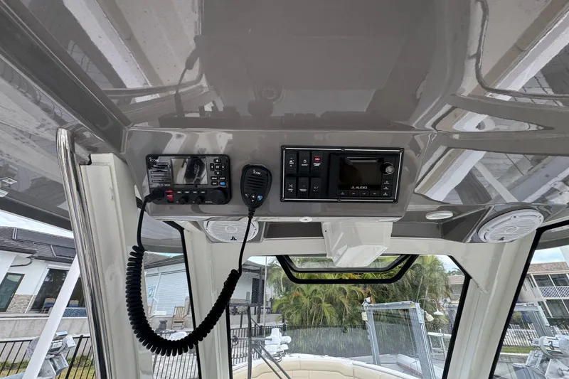 Slide: The Image of 2020 Pursuit S 328 Sport boat dashboard with radio and control panel. - 22