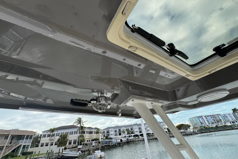 Slide: The Image of 2020 Pursuit S 328 Sport boat roof with open hatch, dockside view. - 23