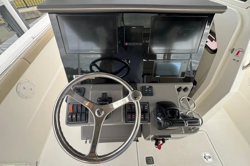 Slide: The Image of 2020 Pursuit S 328 Sport helm with Garmin displays and steering wheel. - 24