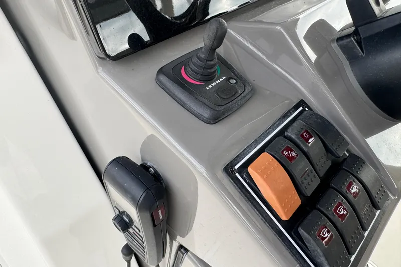 Slide: The Image of Control panel of 2020 Pursuit S 328 Sport boat with joystick and switches. - 25