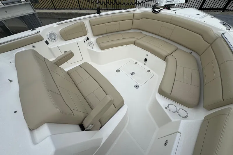 Slide: The Image of 2020 Pursuit S 328 Sport boat with spacious beige seating area. - 27