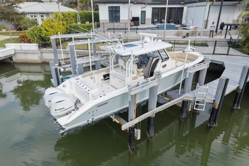 Slide: The Image of 2020 Pursuit S 328 Sport boat docked with dual Yamaha engines. - 3