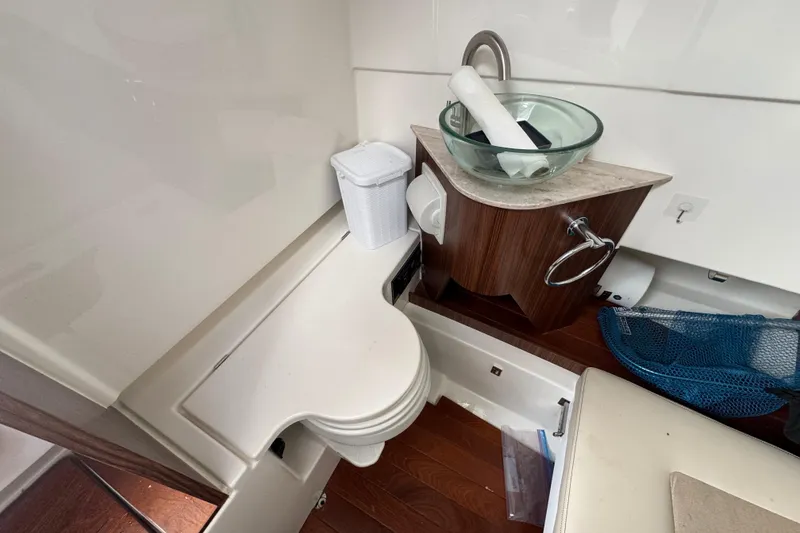 Slide: The Image of 2020 Pursuit S 328 Sport boat interior with sink and storage area. - 31