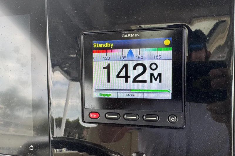 Slide: The Image of Garmin display on 2020 Pursuit S 328 Sport showing 142 degrees in standby mode. - 32