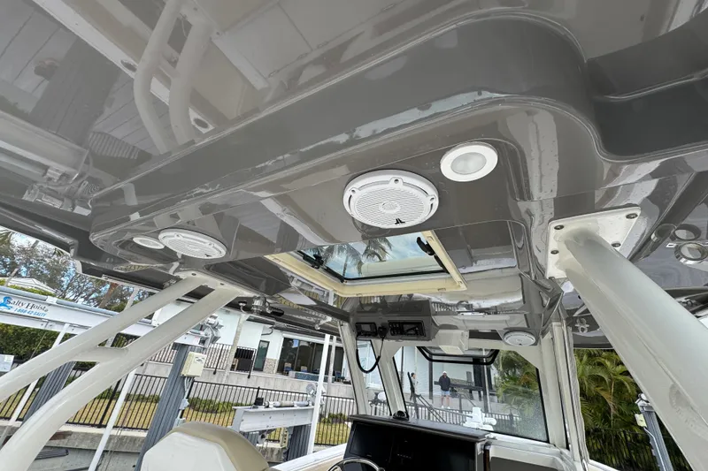 Slide: The Image of 2020 Pursuit S 328 Sport boat interior with speakers and hatch. - 35