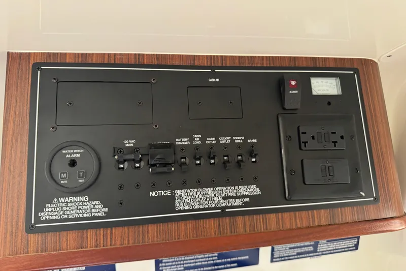 Slide: The Image of Control panel of a 2020 Pursuit S 328 Sport boat with various switches and outlets. - 36