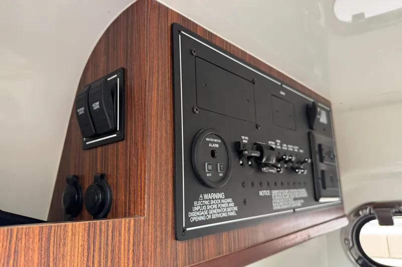 Slide: The Image of Control panel of 2020 Pursuit S 328 Sport boat with wood finish. - 37