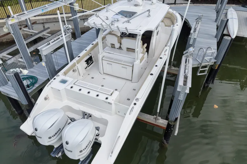 Slide: The Image of 2020 Pursuit S 328 Sport boat with dual Yamaha engines docked at marina. - 5
