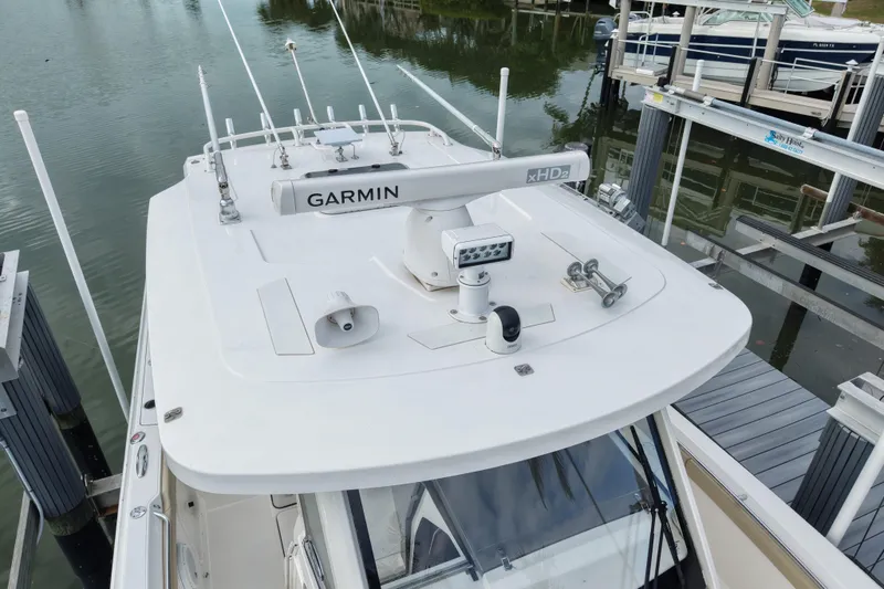 Slide: The Image of 2020 Pursuit S 328 Sport boat with Garmin radar, docked in a marina. - 8