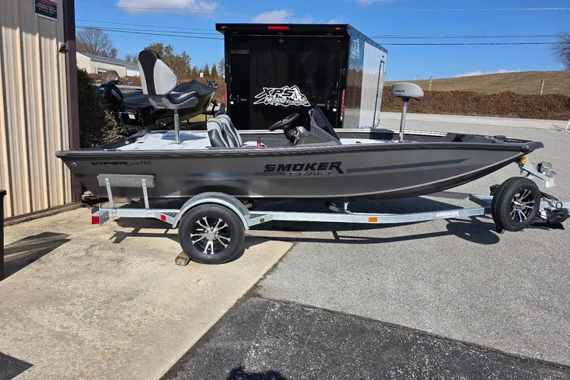 The Image of 2026 Smoker Craft Viper 165 boat on trailer, parked outdoors under clear sky. - 0