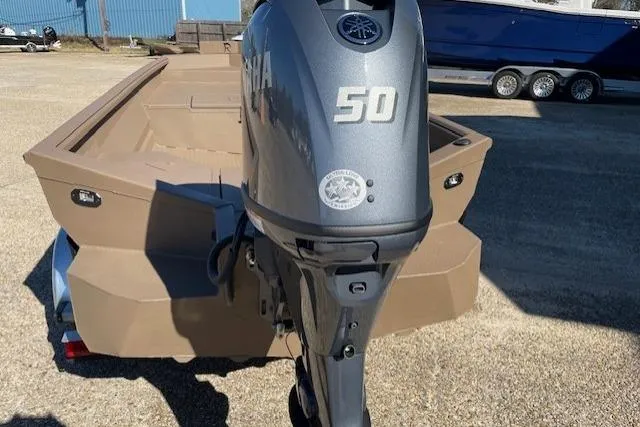 Slide: The Image of 2026 Reaper Boats 653-1884 with Yamaha 50 outboard motor, parked outdoors. - 4