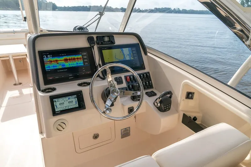 Slide: The Image of Grady-White Freedom 325 helm, 2018 model, featuring advanced navigation systems. - 5