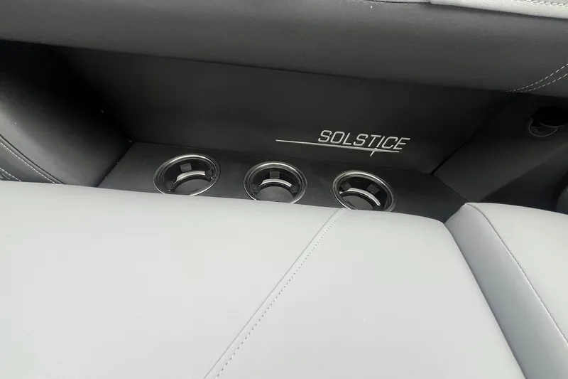 Slide: The Image of 2025 Harris Solstice 230 interior with cup holders and logo detail. - 11