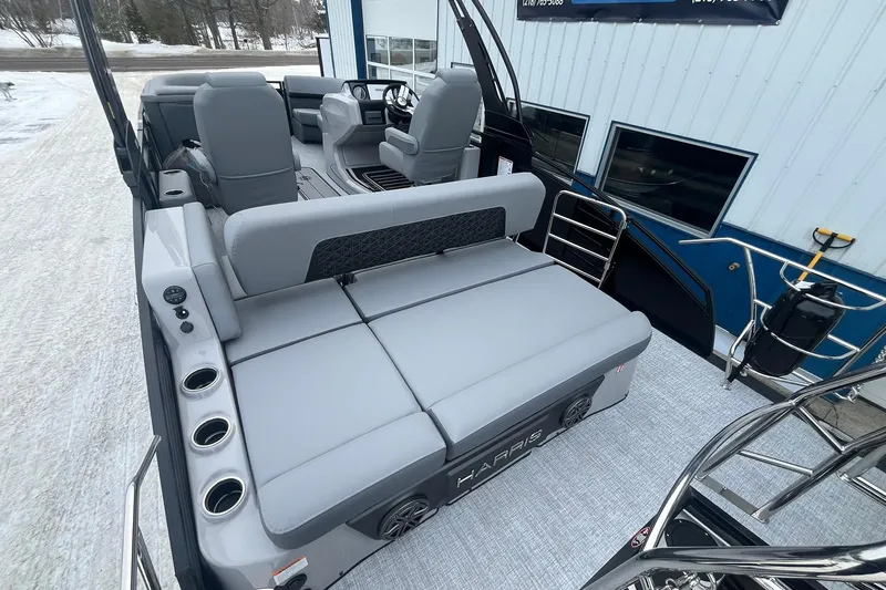 Slide: The Image of 2025 Harris Solstice 230 boat interior with gray seating and cup holders. - 17