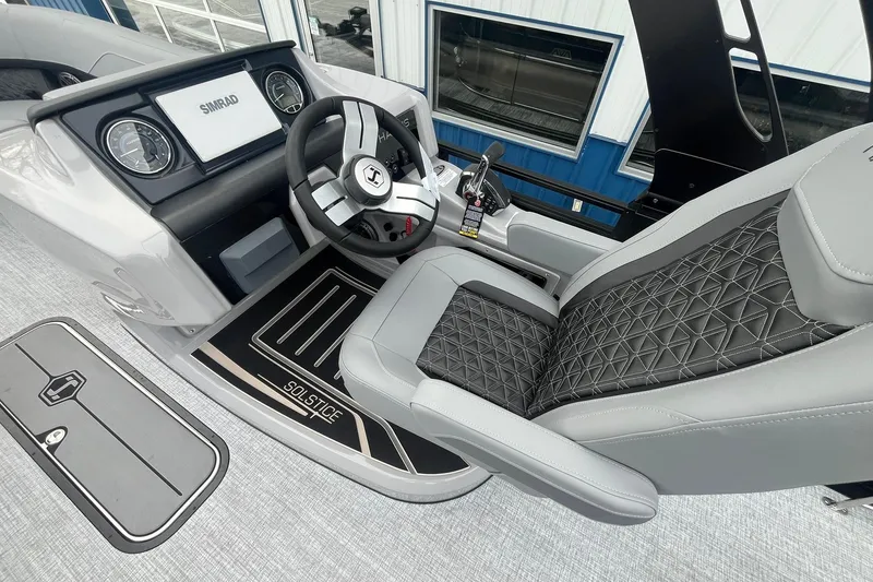 Slide: The Image of 2025 Harris Solstice 230 boat cockpit with modern steering and luxurious seating. - 22