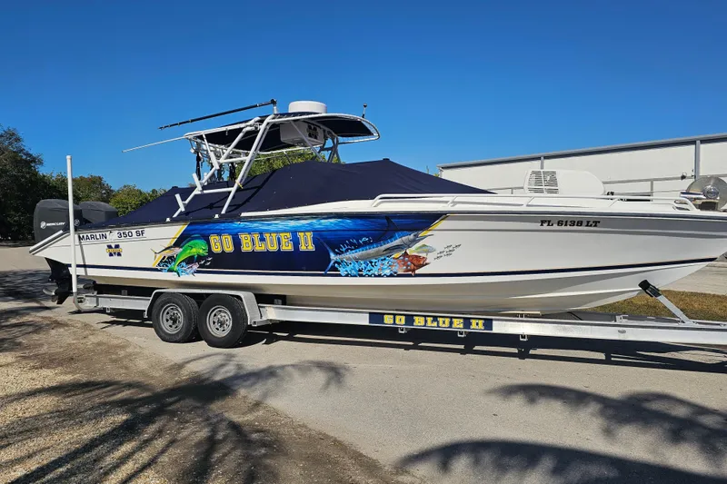 Slide: The Image of 1993 Marlin 350 Sportfish boat "Go Blue II" on trailer, vibrant marine graphics. - 10