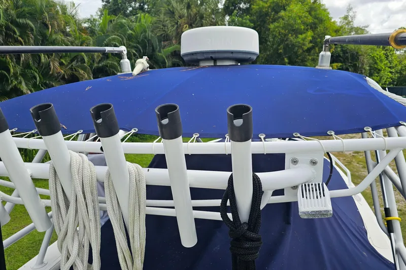 Slide: The Image of 1993 Marlin 350 Sportfish boat with blue canopy and rod holders. - 12