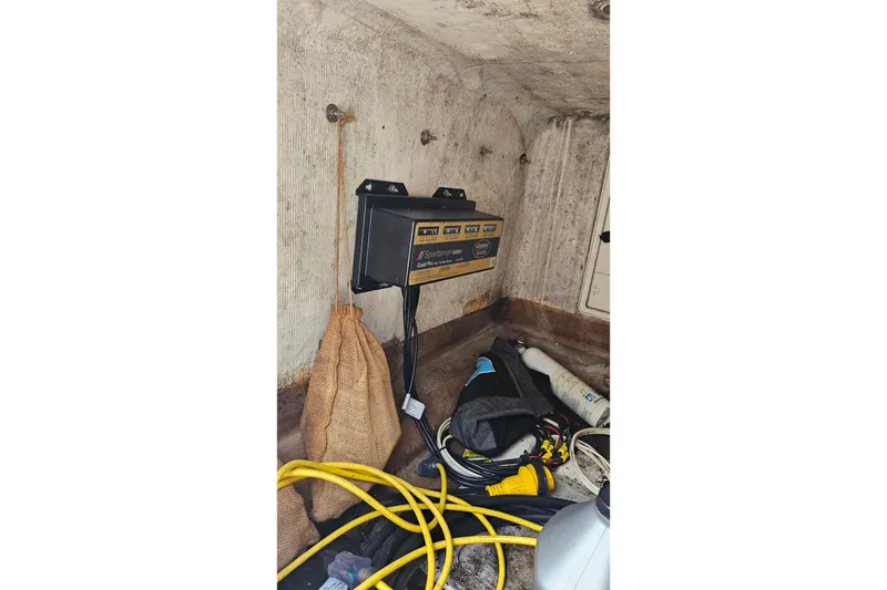 Slide: The Image of Storage compartment of a 1993 Marlin 350 Sportfish with equipment and cables. - 13