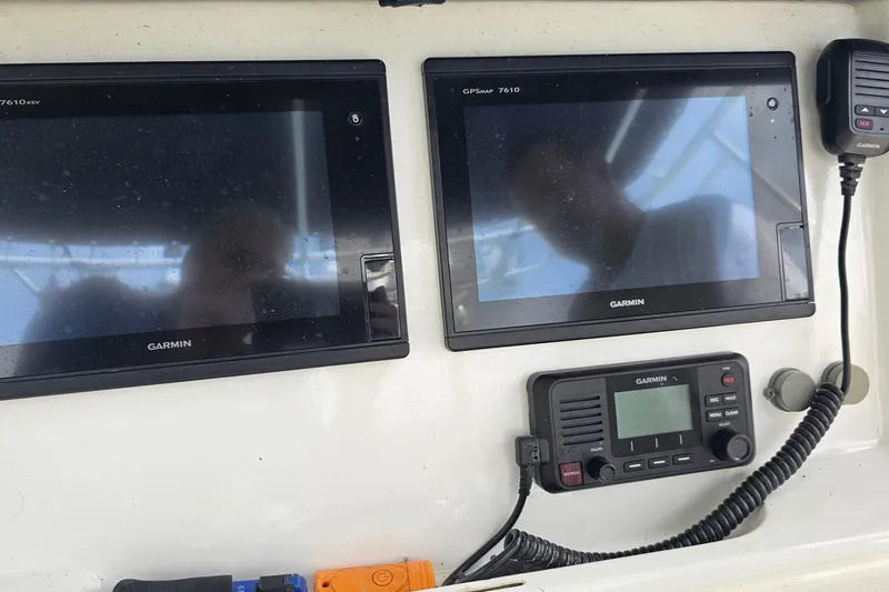 Slide: The Image of Control panel of a 1993 Marlin 350 Sportfish with Garmin displays and radio. - 18