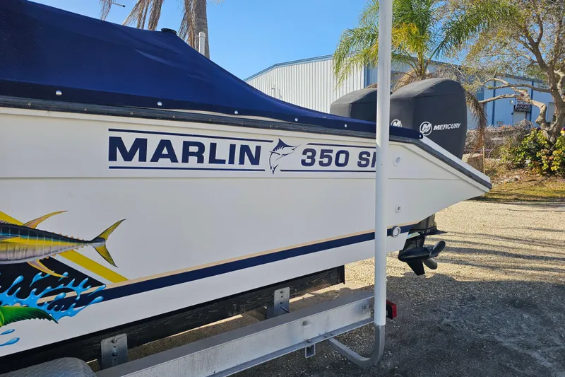 Slide: The Image of 1993 Marlin 350 Sportfish boat with Mercury engine, parked outdoors. - 2