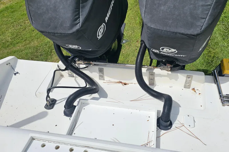 Slide: The Image of 1993 Marlin 350 Sportfish boat with dual Mercury engines, grass background. - 21