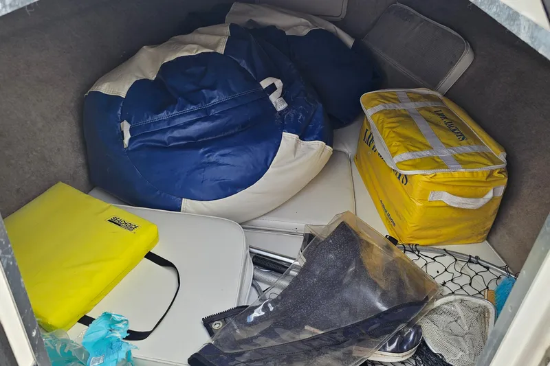 Slide: The Image of Storage area in a 1993 Marlin 350 Sportfish with boating gear and equipment. - 23