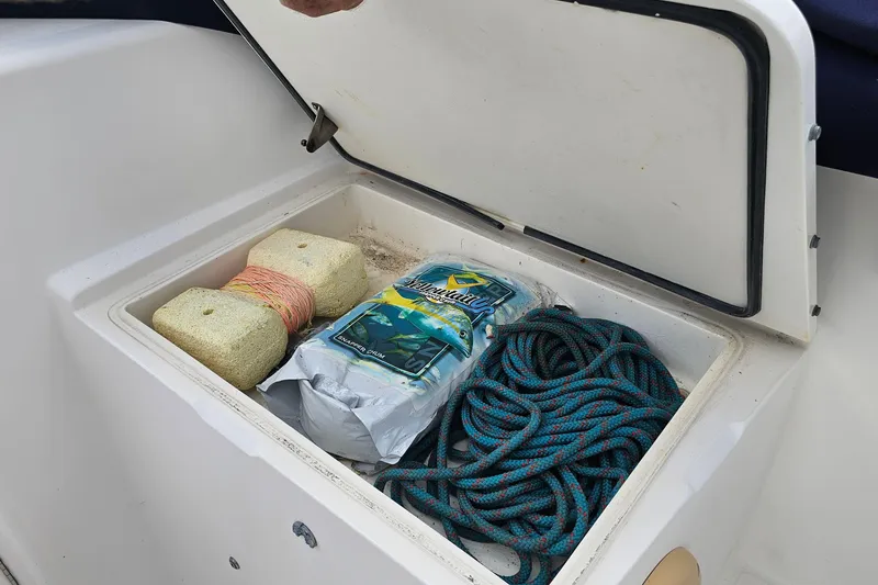 Slide: The Image of Storage compartment on 1993 Marlin 350 Sportfish boat with rope and cleaning supplies. - 24
