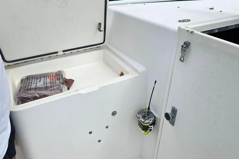 Slide: The Image of Open storage compartment on 1993 Marlin 350 Sportfish boat with emergency equipment. - 25