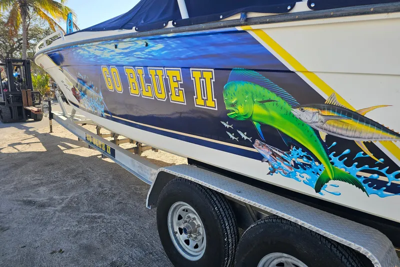 Slide: The Image of 1993 Marlin 350 Sportfish boat with vibrant marine graphics and "Go Blue II" text. - 3