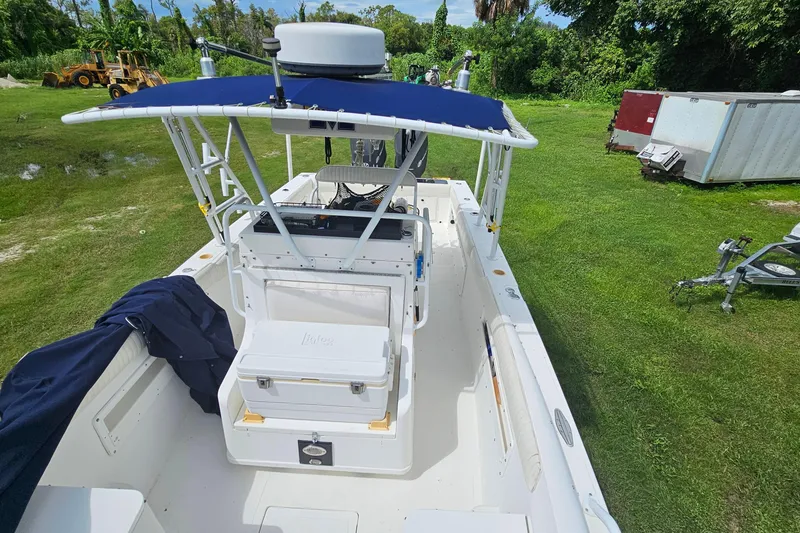 Slide: The Image of 1993 Marlin 350 Sportfish boat with blue canopy on grassy area. - 33