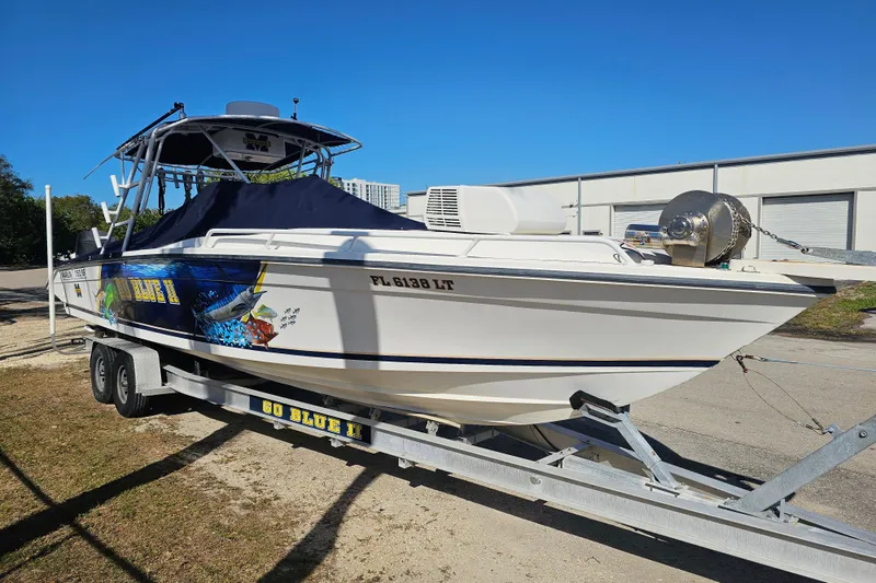 Slide: The Image of 1993 Marlin 350 Sportfish boat on trailer, vibrant graphics, sunny day. - 8