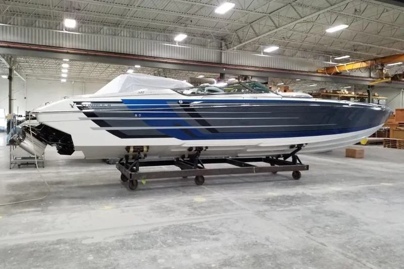 Slide: The Image of 2019 Formula 382 FASTech boat in a warehouse, showcasing sleek design and blue accents. - 1