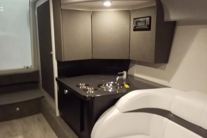 Slide: The Image of 2019 Formula 382 FASTech cabin interior with modern kitchenette and seating area. - 13