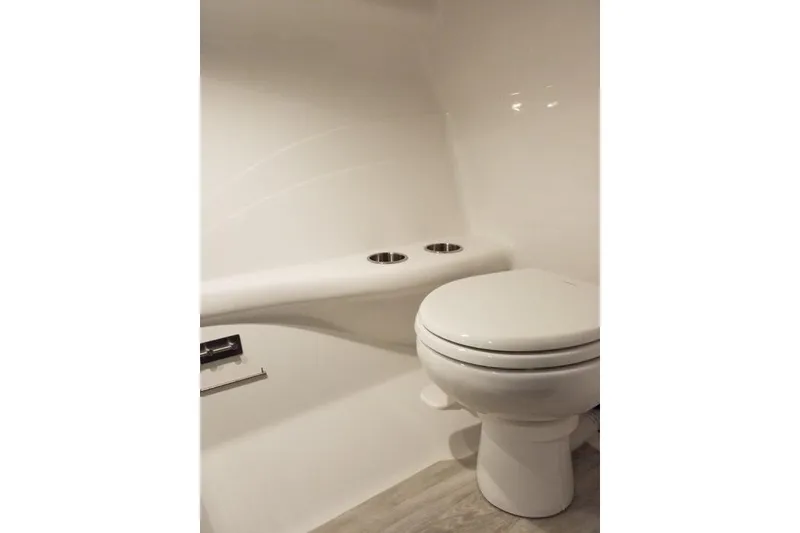 Slide: The Image of 2019 Formula 382 FASTech boat bathroom with white toilet and sleek design. - 15